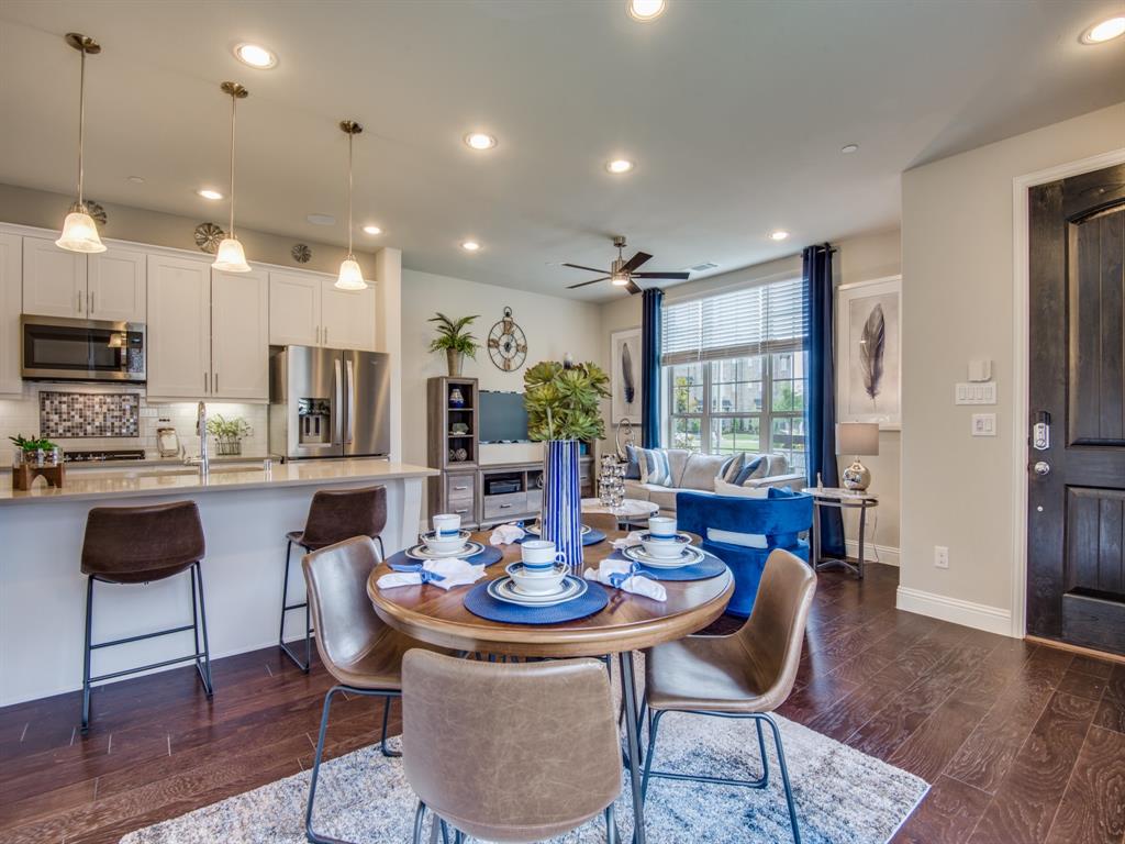8144 Foraker Street Frisco, TX 75034 - Photo 1 of 1 a kitchen with a dining table and chairs