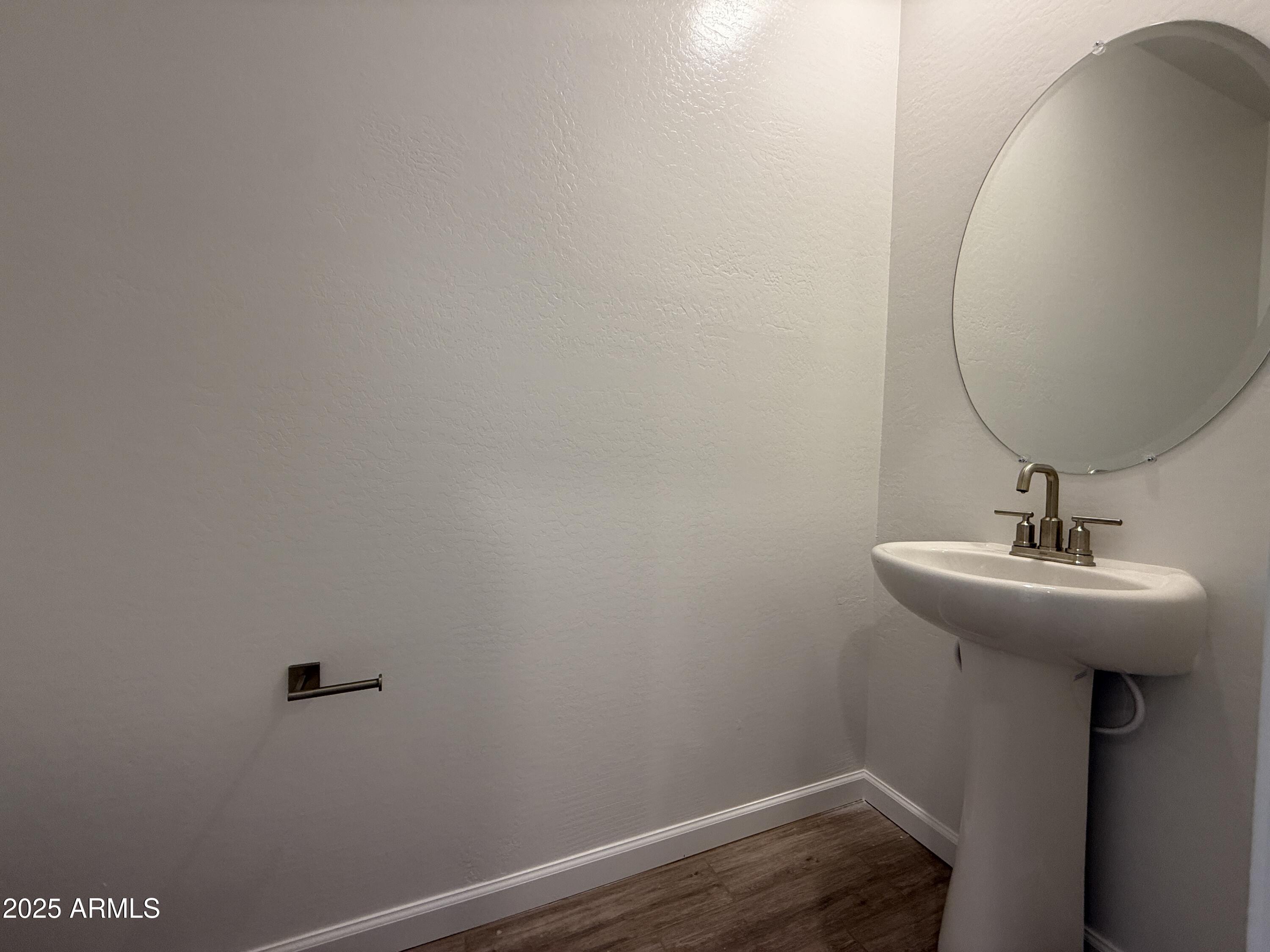 9628 West Tamarisk Avenue Tolleson, AZ 85353 - Photo 12 of 37 a bathroom with a sink and mirror