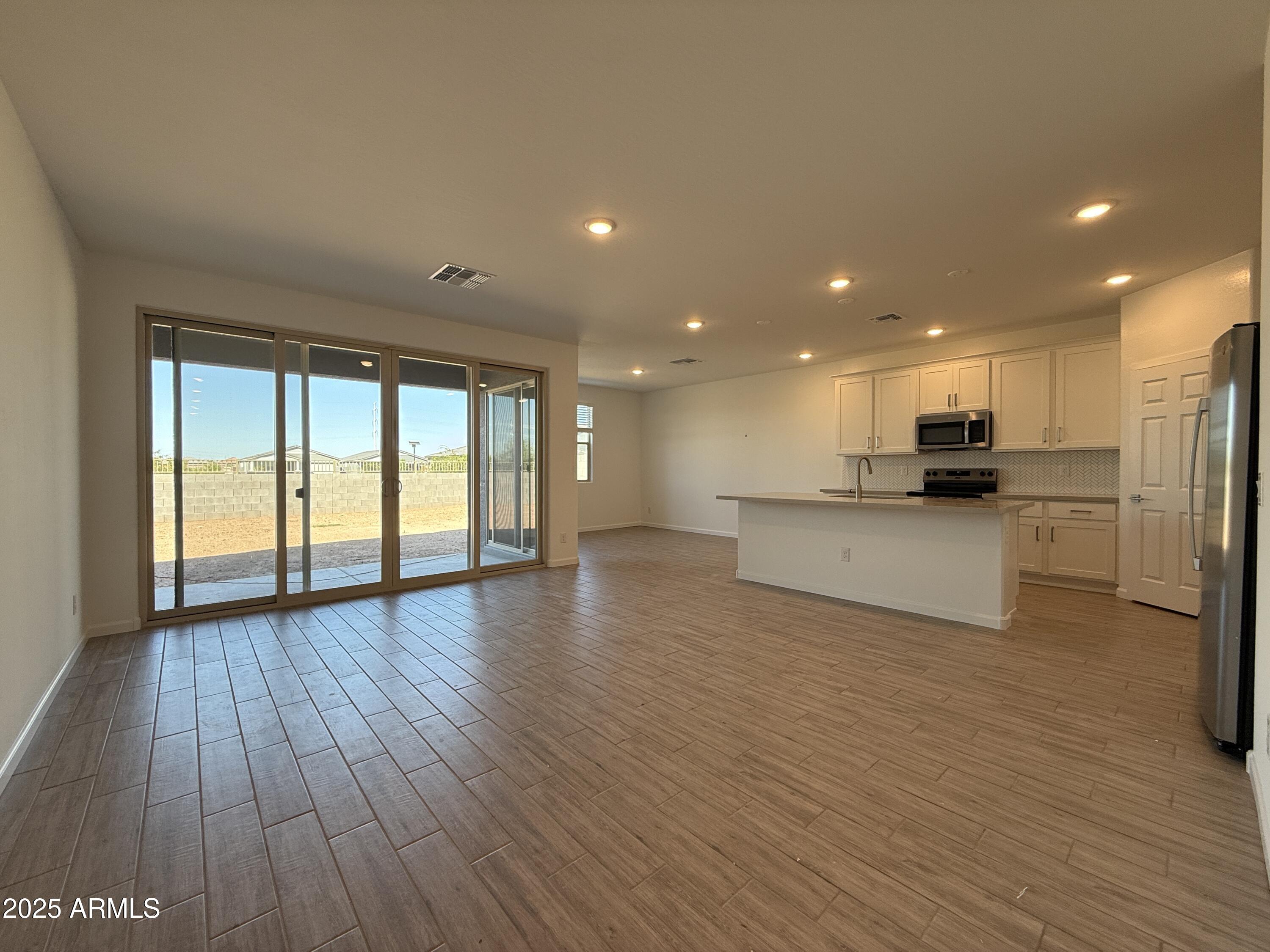 9628 West Tamarisk Avenue Tolleson, AZ 85353 - Photo 13 of 37 a view of kitchen with cabinets and wooden floor