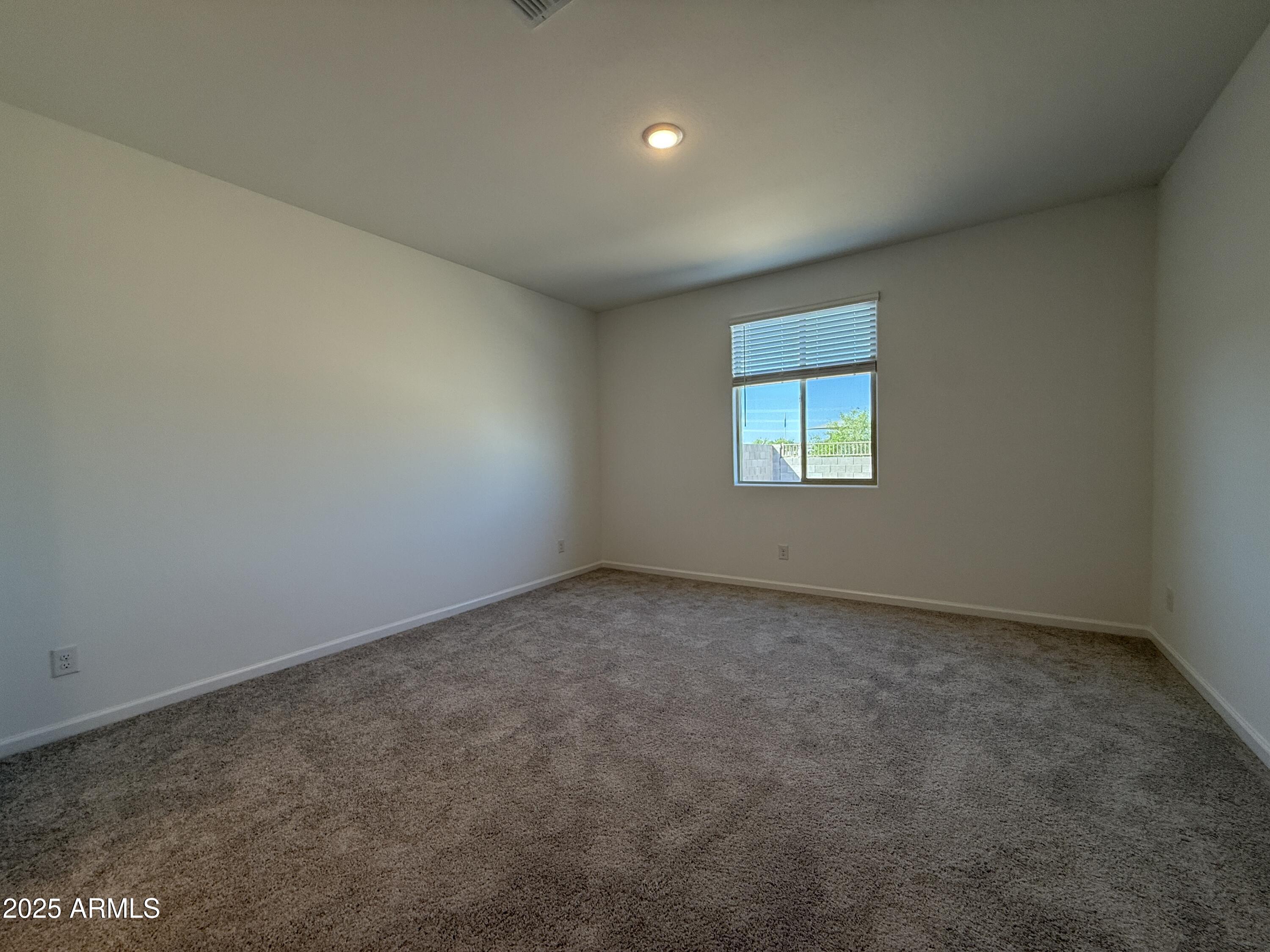 9628 West Tamarisk Avenue Tolleson, AZ 85353 - Photo 25 of 37 an empty room with a window