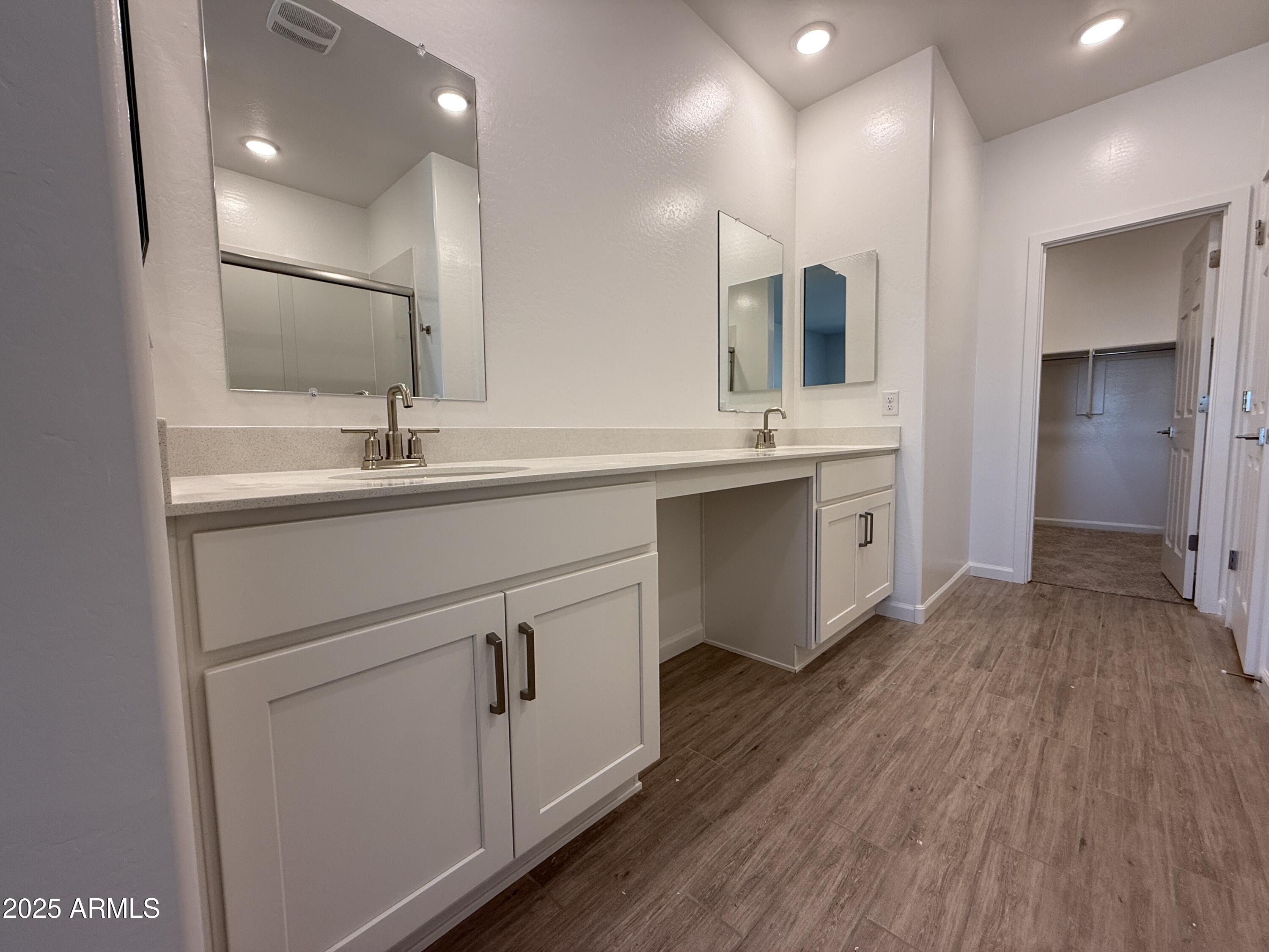 9628 West Tamarisk Avenue Tolleson, AZ 85353 - Photo 27 of 37 a bathroom with a sink double vanity granite and a mirror