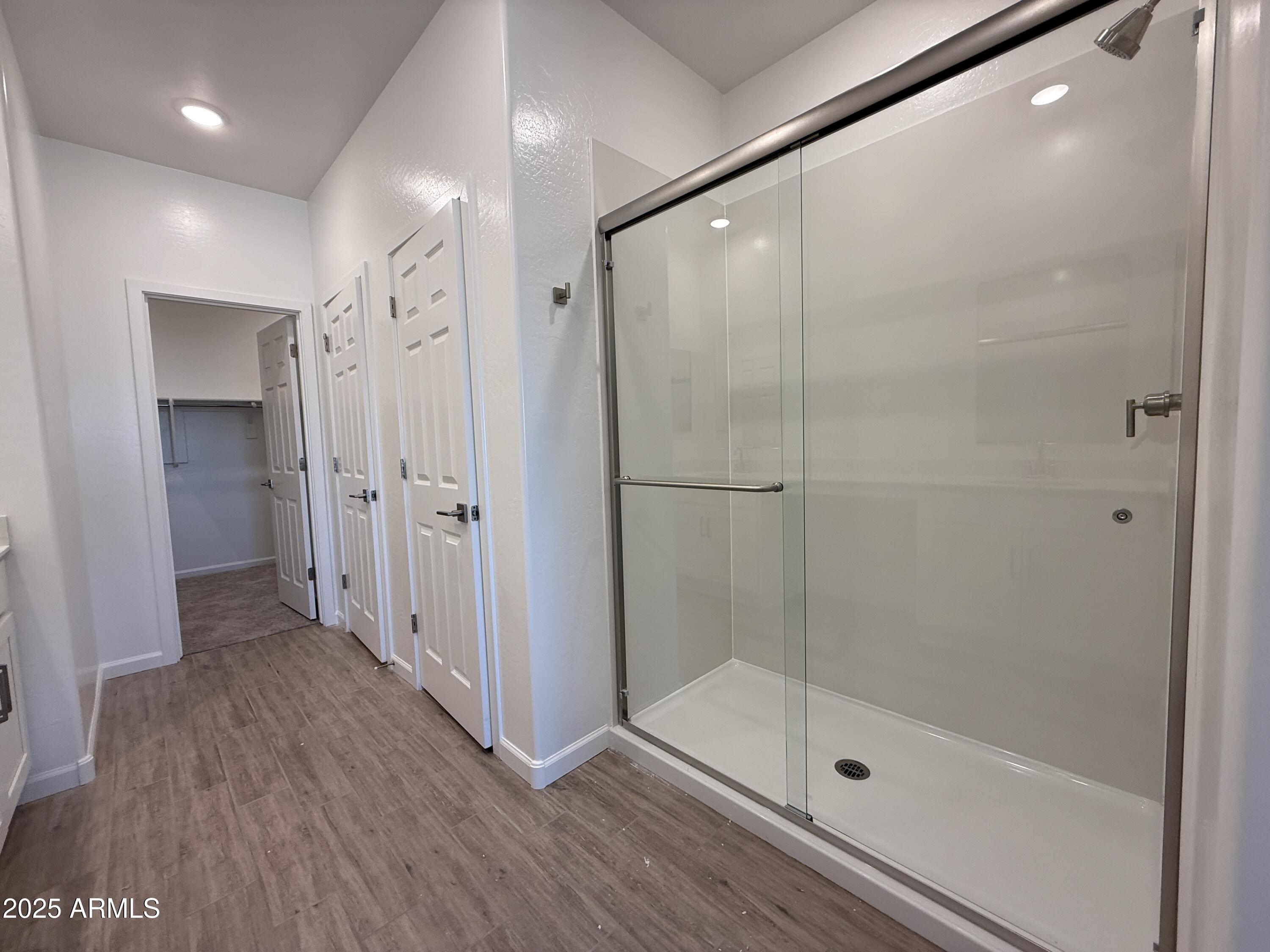 9628 West Tamarisk Avenue Tolleson, AZ 85353 - Photo 28 of 37 a bathroom with a shower and a glass door