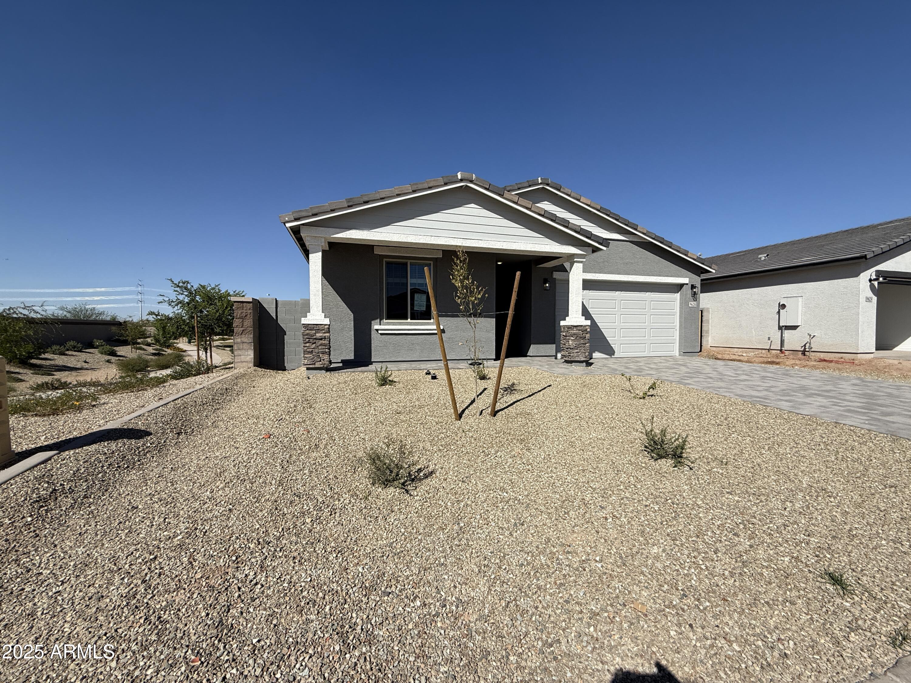 9628 West Tamarisk Avenue Tolleson, AZ 85353 - Photo 3 of 37 a view of a house with a snow in the yard