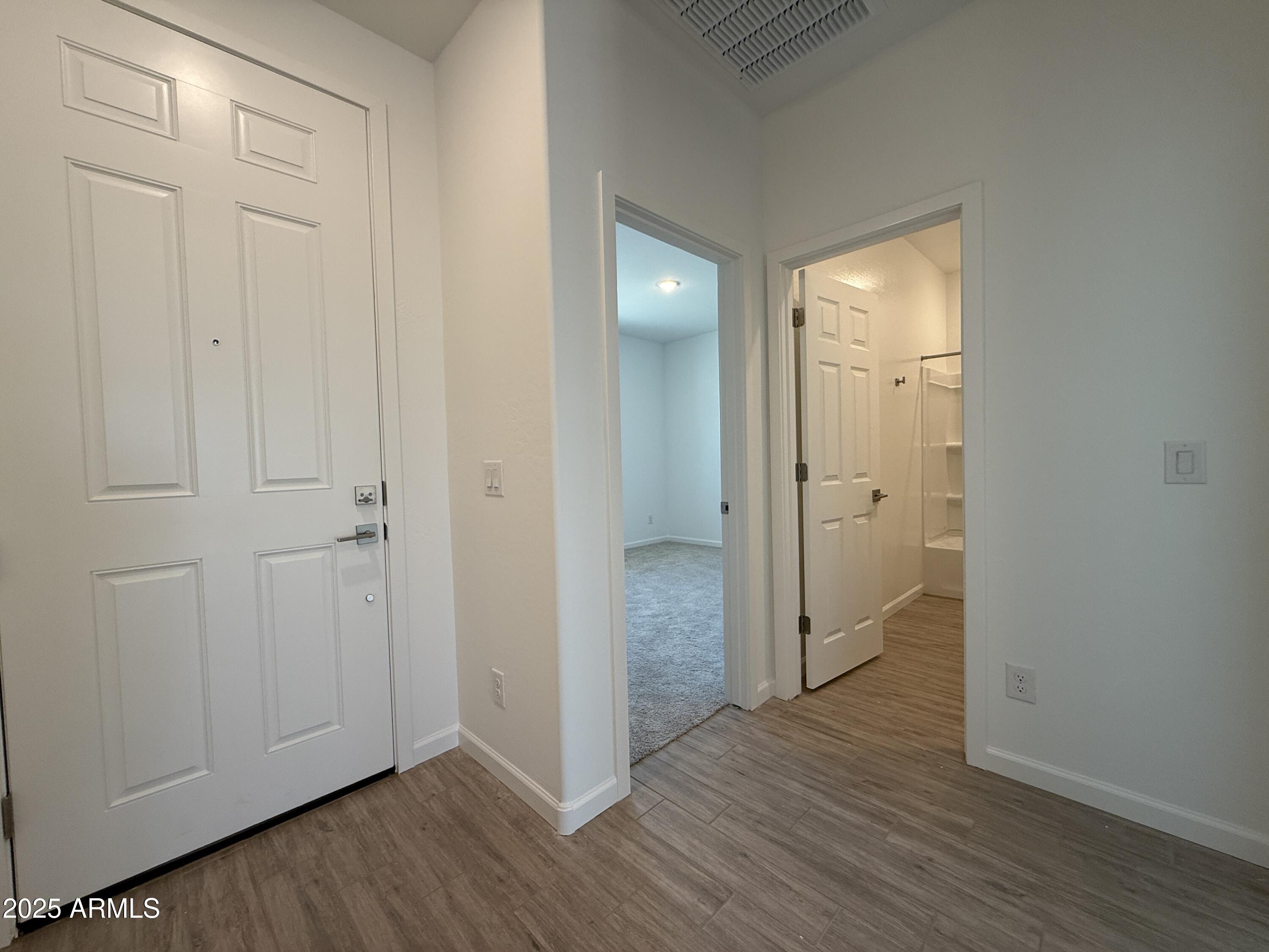9628 West Tamarisk Avenue Tolleson, AZ 85353 - Photo 5 of 37 an empty room with wooden floor & closet area