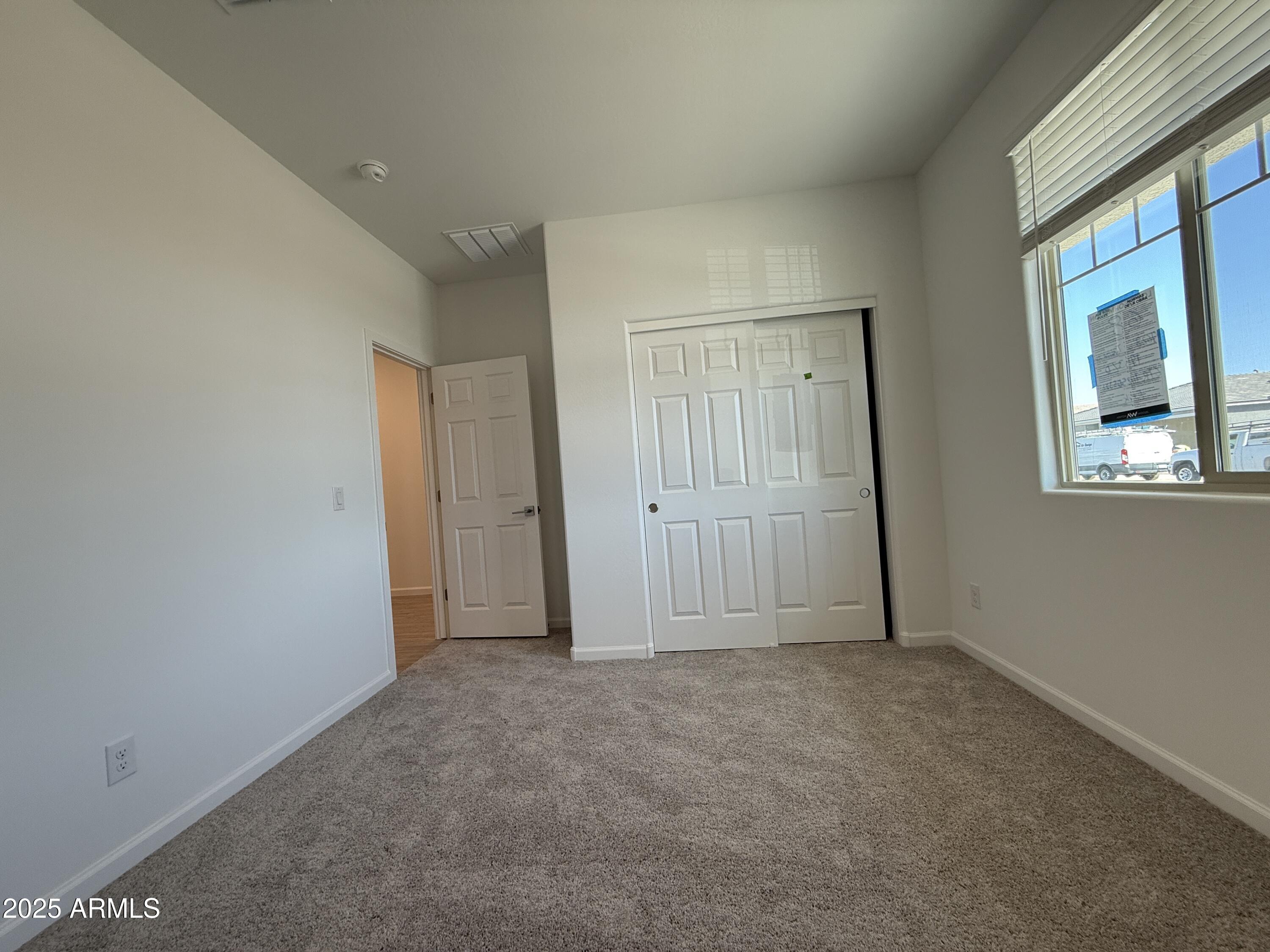 9628 West Tamarisk Avenue Tolleson, AZ 85353 - Photo 6 of 37 a view of an empty room with a window