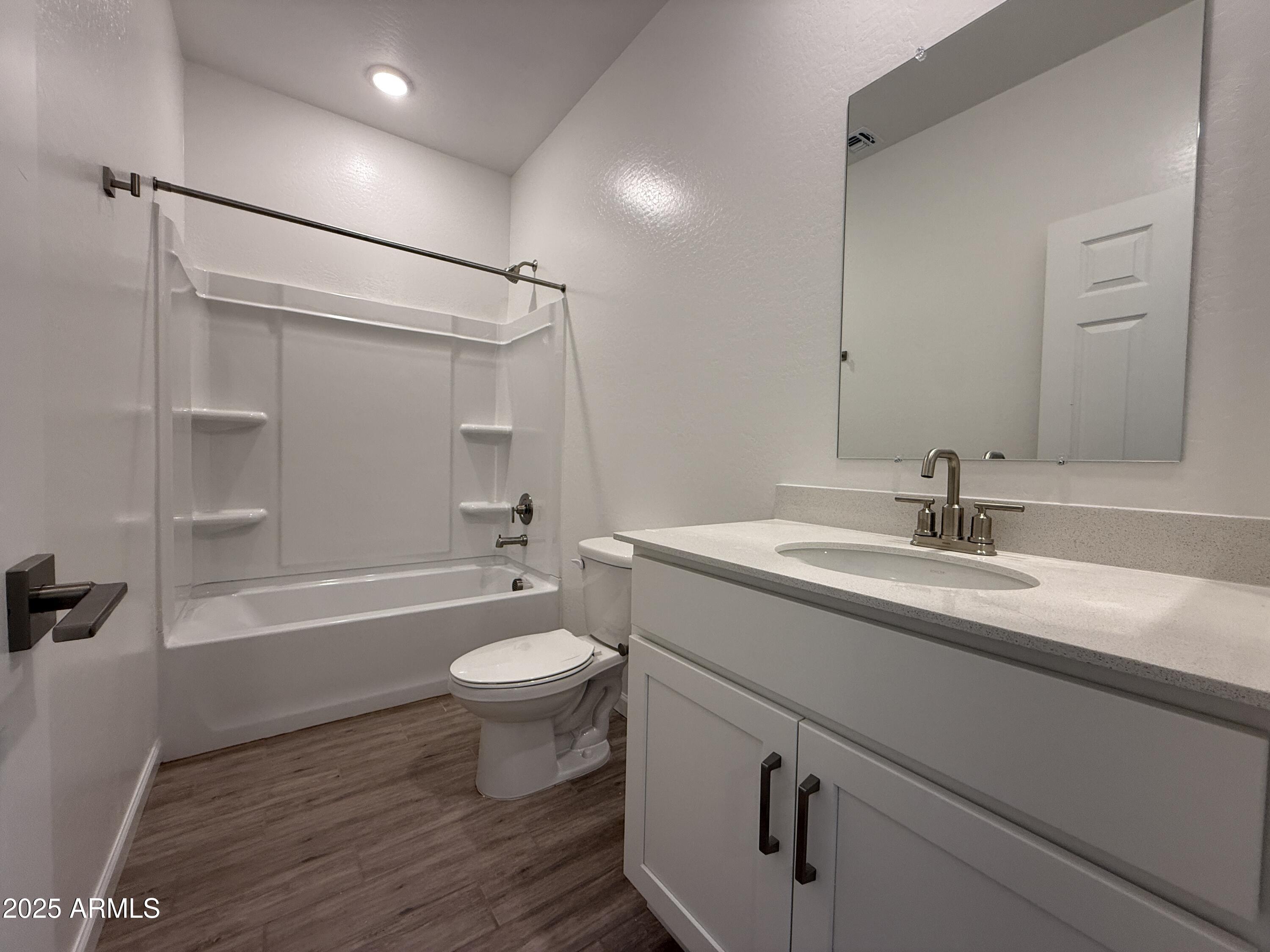 9628 West Tamarisk Avenue Tolleson, AZ 85353 - Photo 7 of 37 a bathroom with a sink a toilet and shower