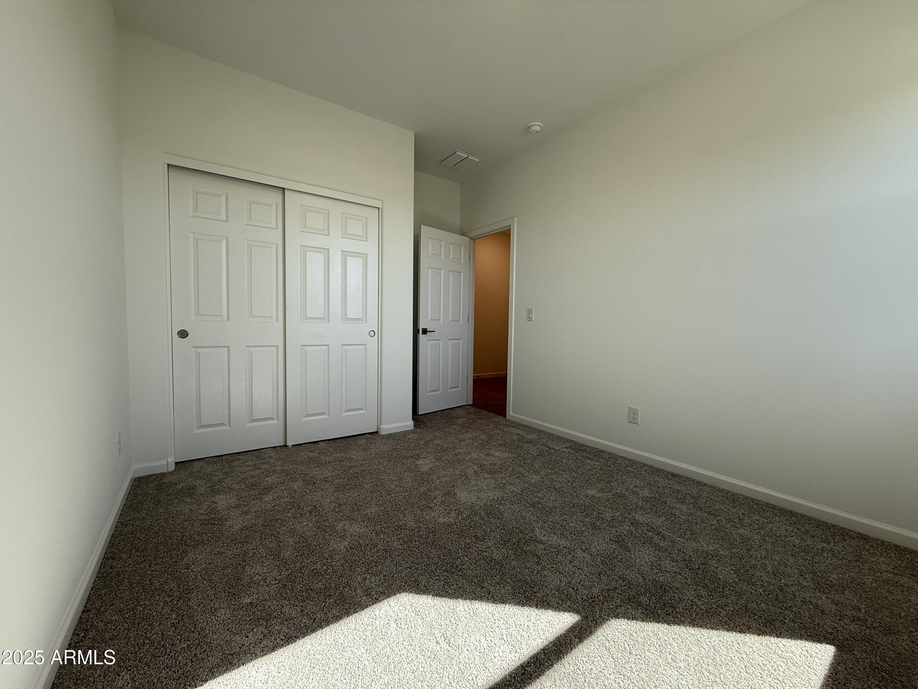 9628 West Tamarisk Avenue Tolleson, AZ 85353 - Photo 8 of 37 a view of an empty room