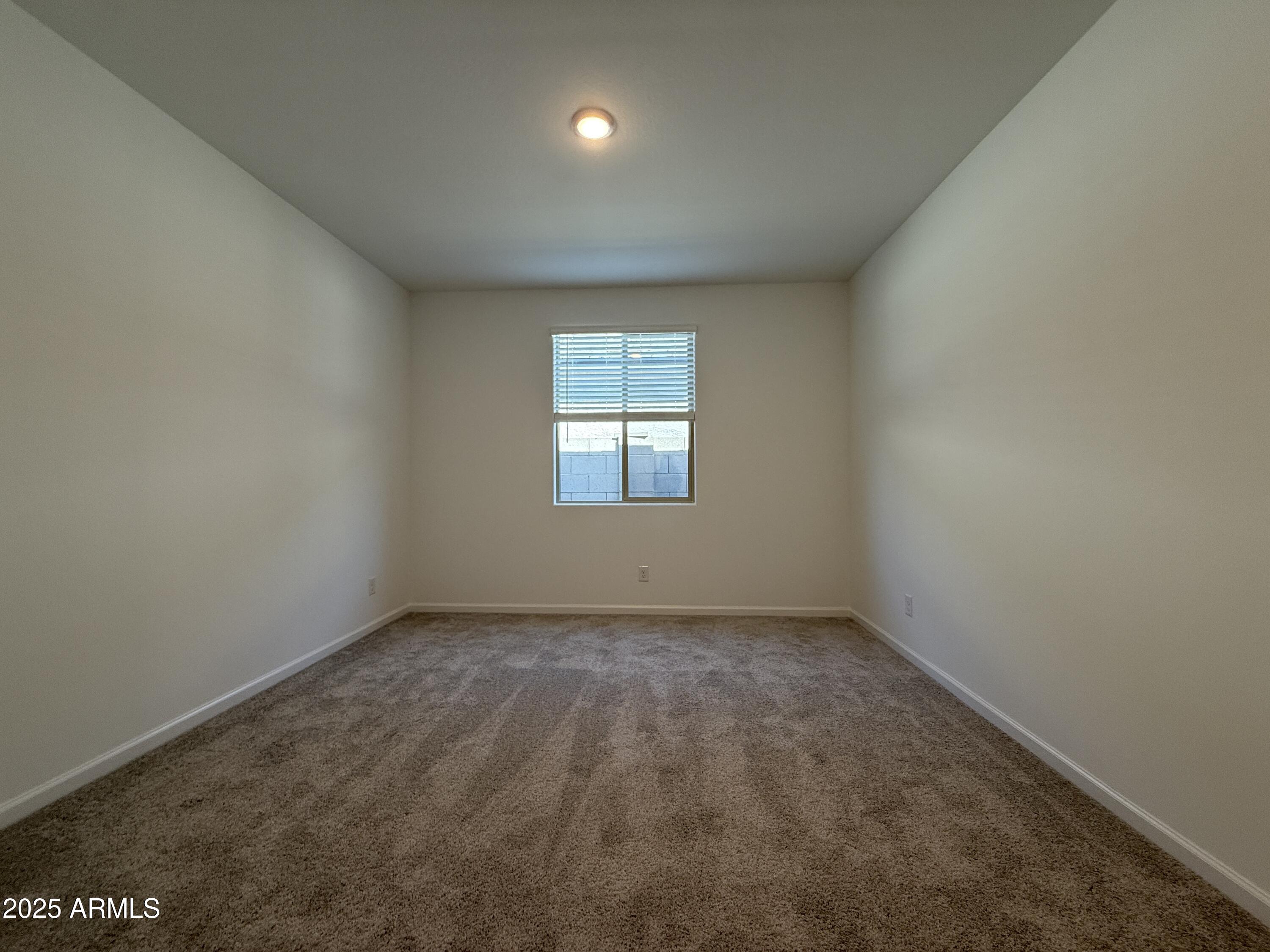 9628 West Tamarisk Avenue Tolleson, AZ 85353 - Photo 10 of 37 an empty room with a window