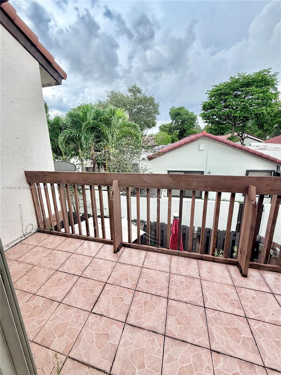 11028 Southwest 132nd Place, Unit 244 Miami, FL 33186 - Photo 23 of 25 a view of wooden balcony