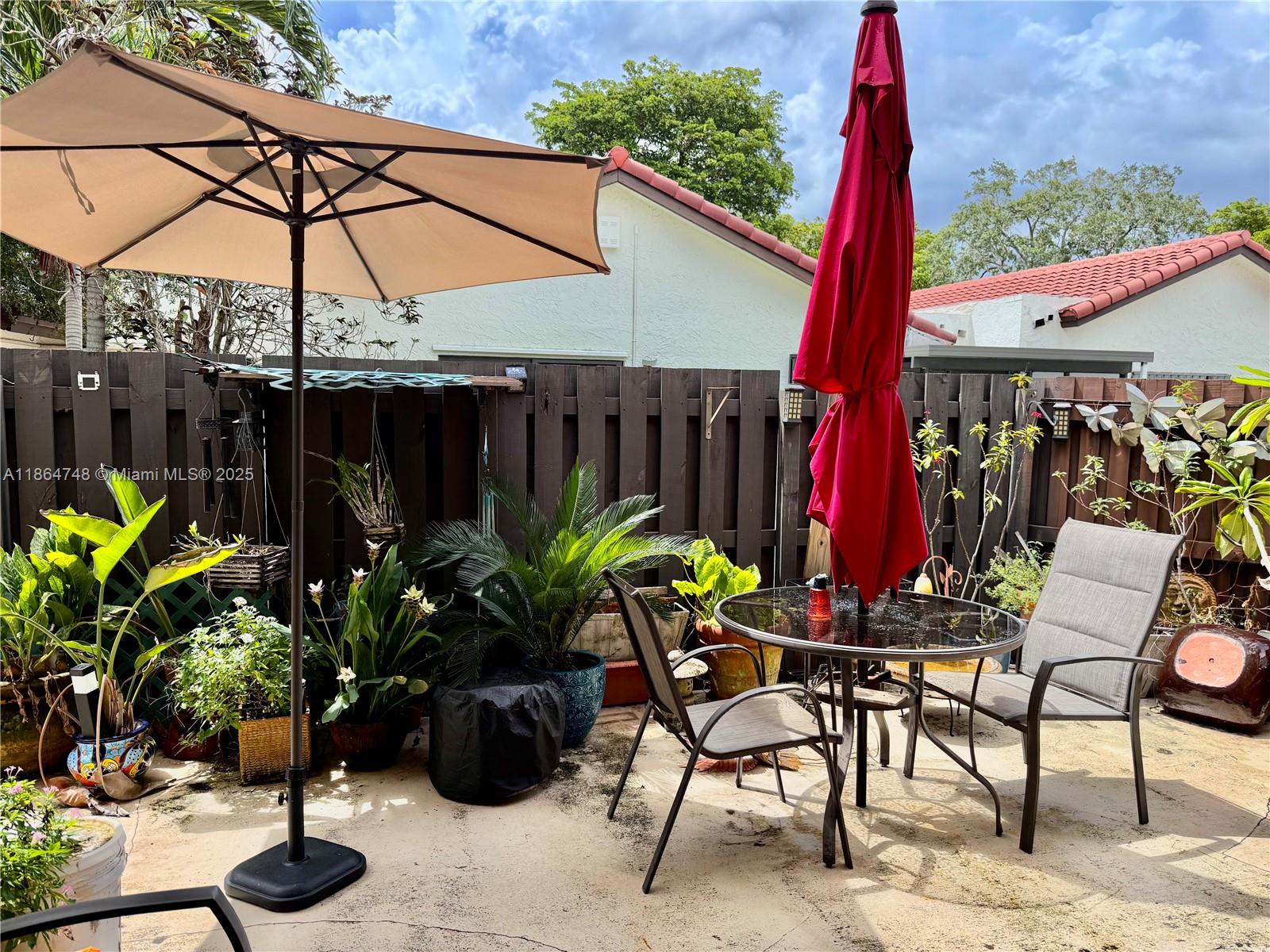 11028 Southwest 132nd Place, Unit 244 Miami, FL 33186 - Photo 25 of 25 a view of a chairs and table in patio with a potted plant