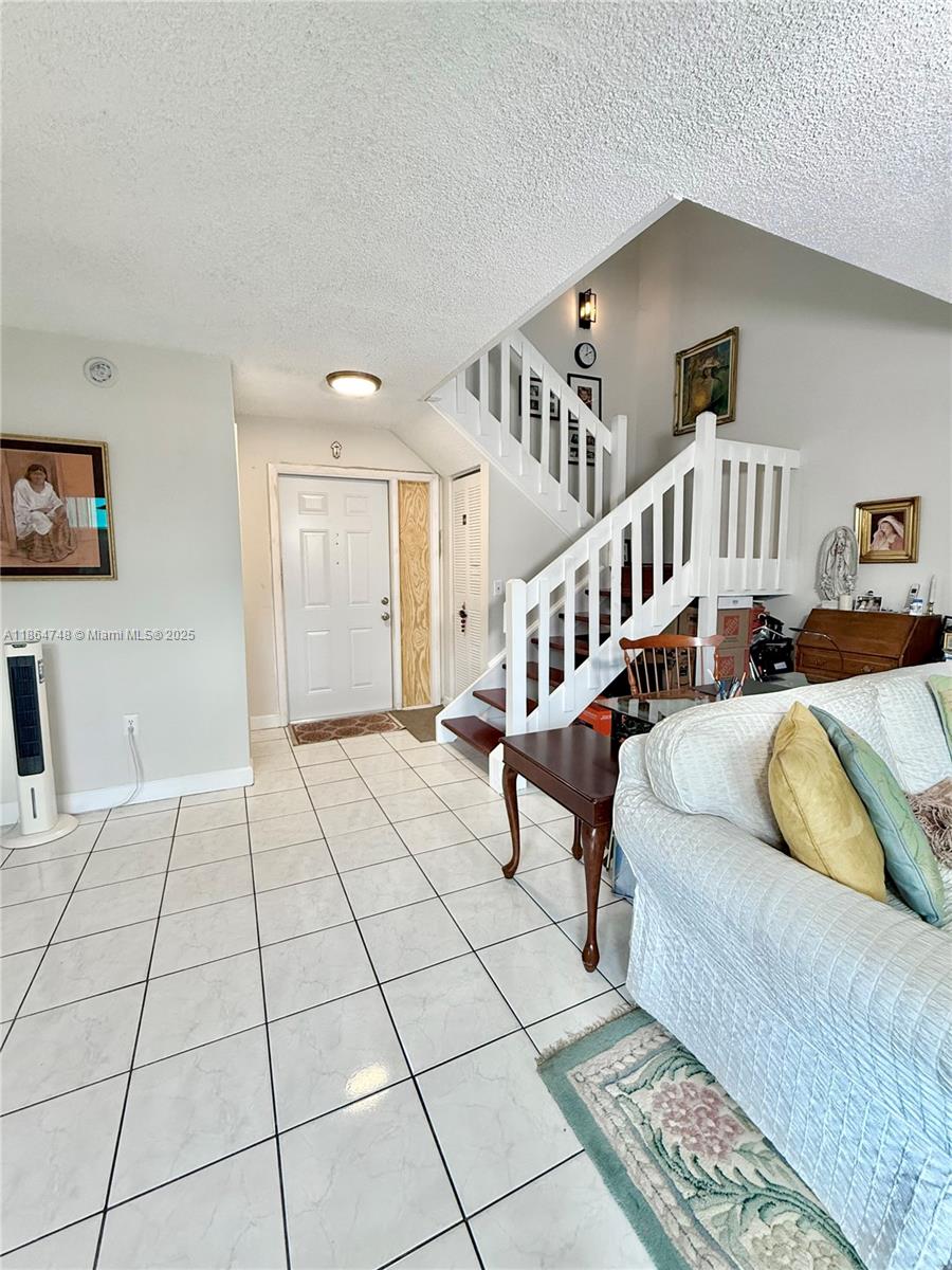11028 Southwest 132nd Place, Unit 244 Miami, FL 33186 - Photo 4 of 25 a living room with furniture and a window