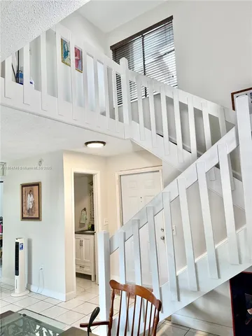a view of an entryway with wooden floor and windows