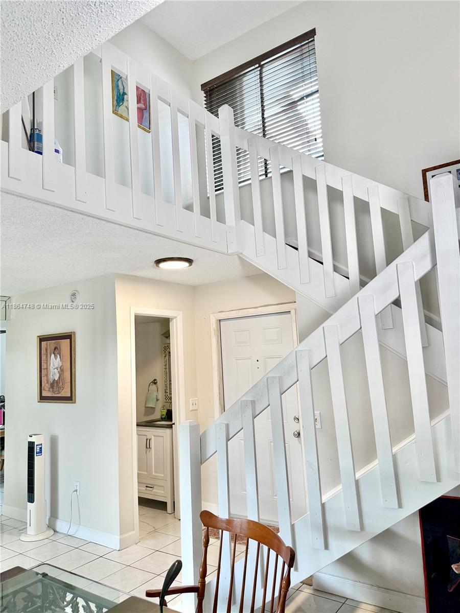 11028 Southwest 132nd Place, Unit 244 Miami, FL 33186 - Photo 5 of 25 a view of an entryway with wooden floor and windows