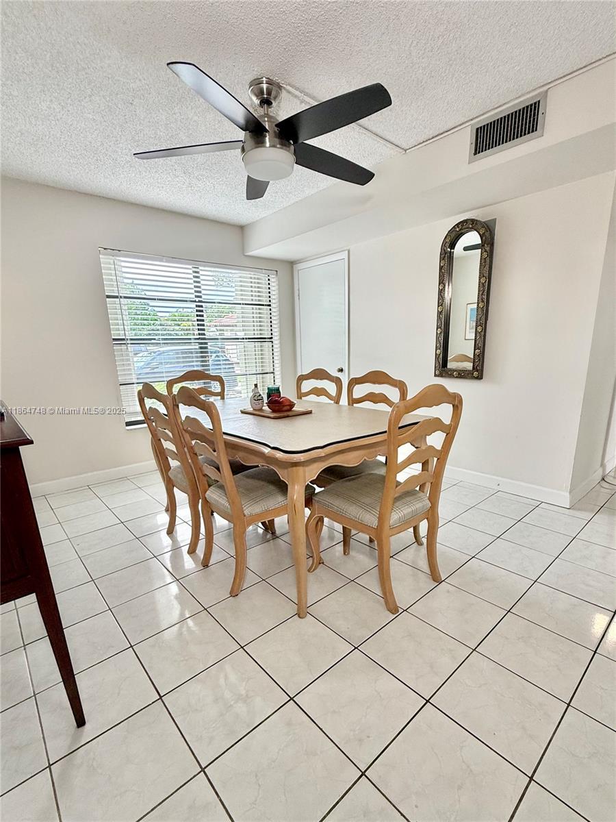 11028 Southwest 132nd Place, Unit 244 Miami, FL 33186 - Photo 10 of 25 a view of a dining room that has a table and a chair in it