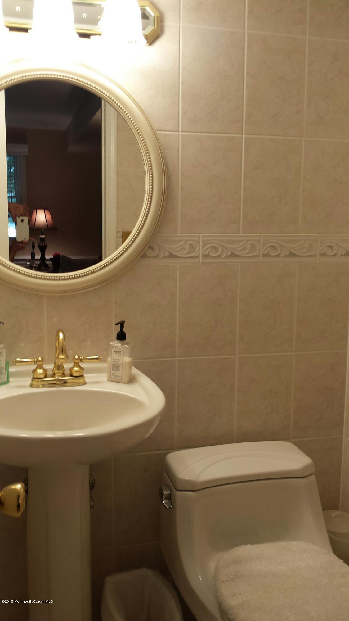 6 Buxton Road Jackson, NJ 08527 - Photo 30 of 41 a bathroom with a toilet a sink and mirror