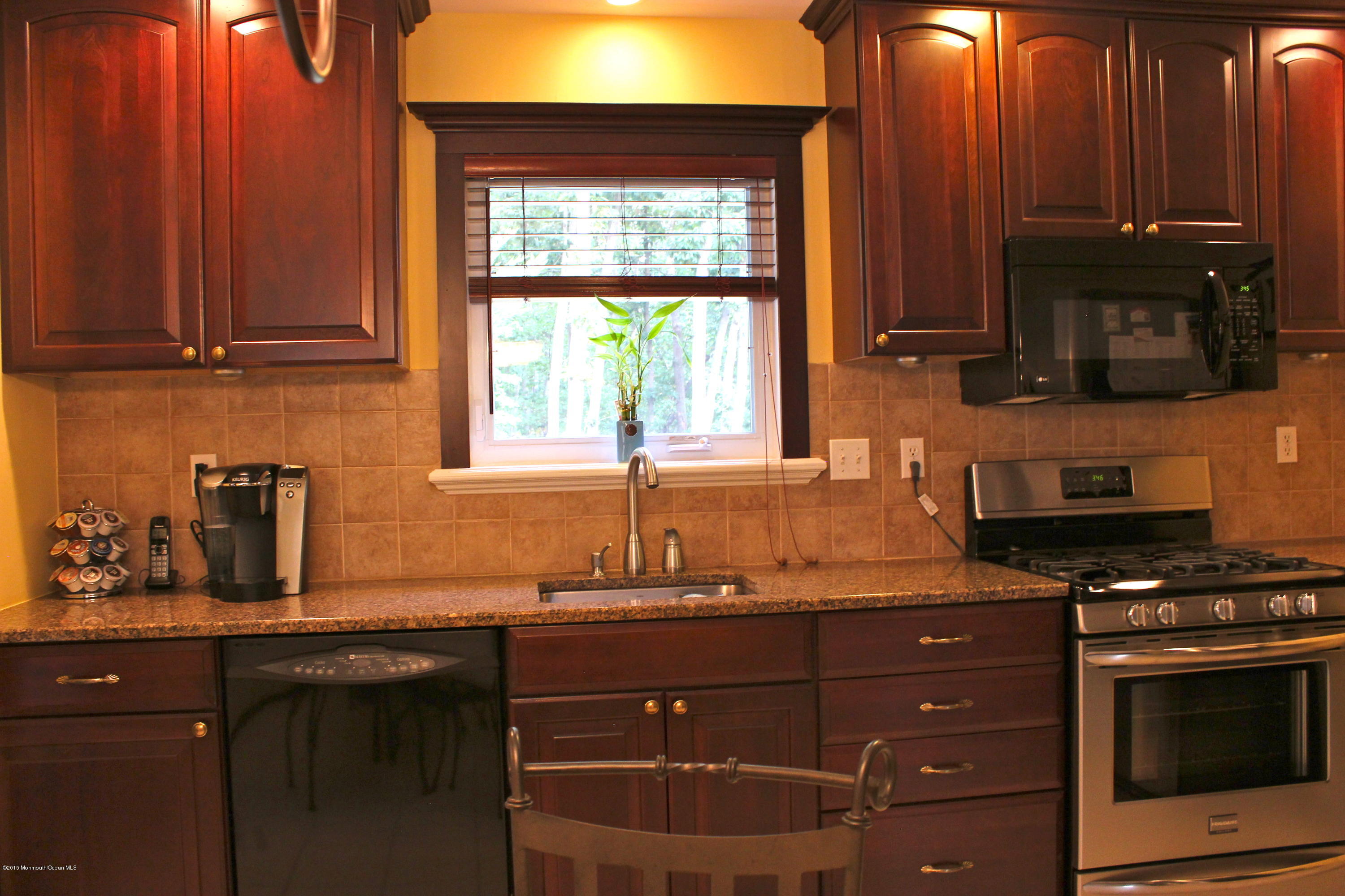 6 Buxton Road Jackson, NJ 08527 - Photo 4 of 41 a kitchen with granite countertop wooden cabinets and a stove top oven