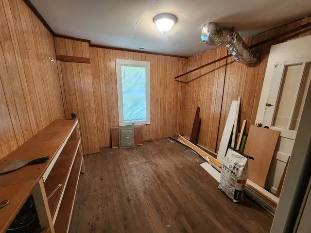 a bathroom with a granite countertop sink a toilet a mirror and shower