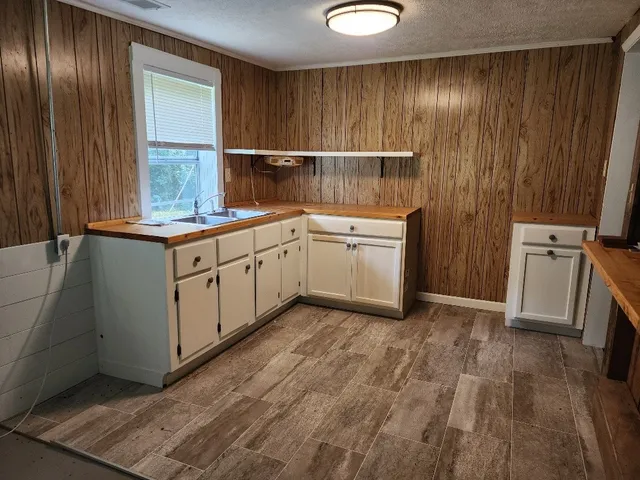 a front view of house with a garden