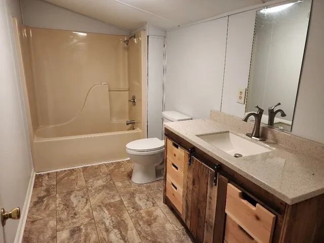 a view of a house with a yard and sitting area