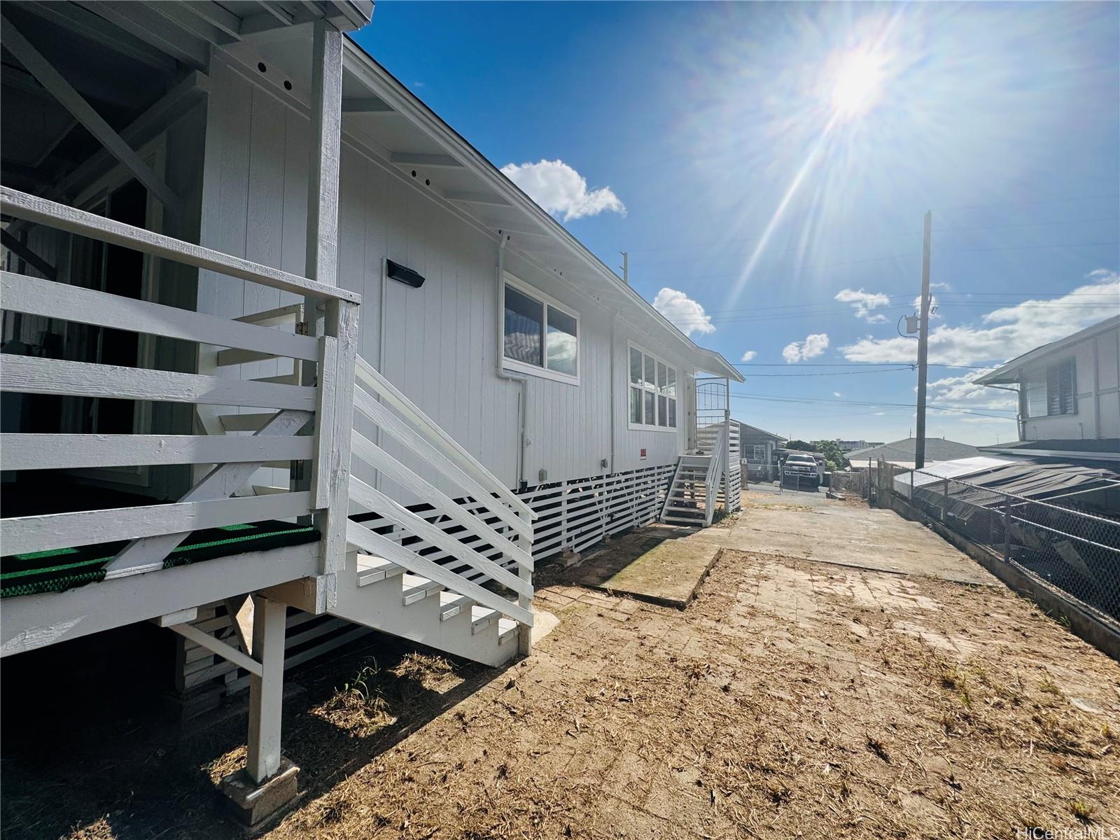 a view of a livingroom with wooden floor and staircase