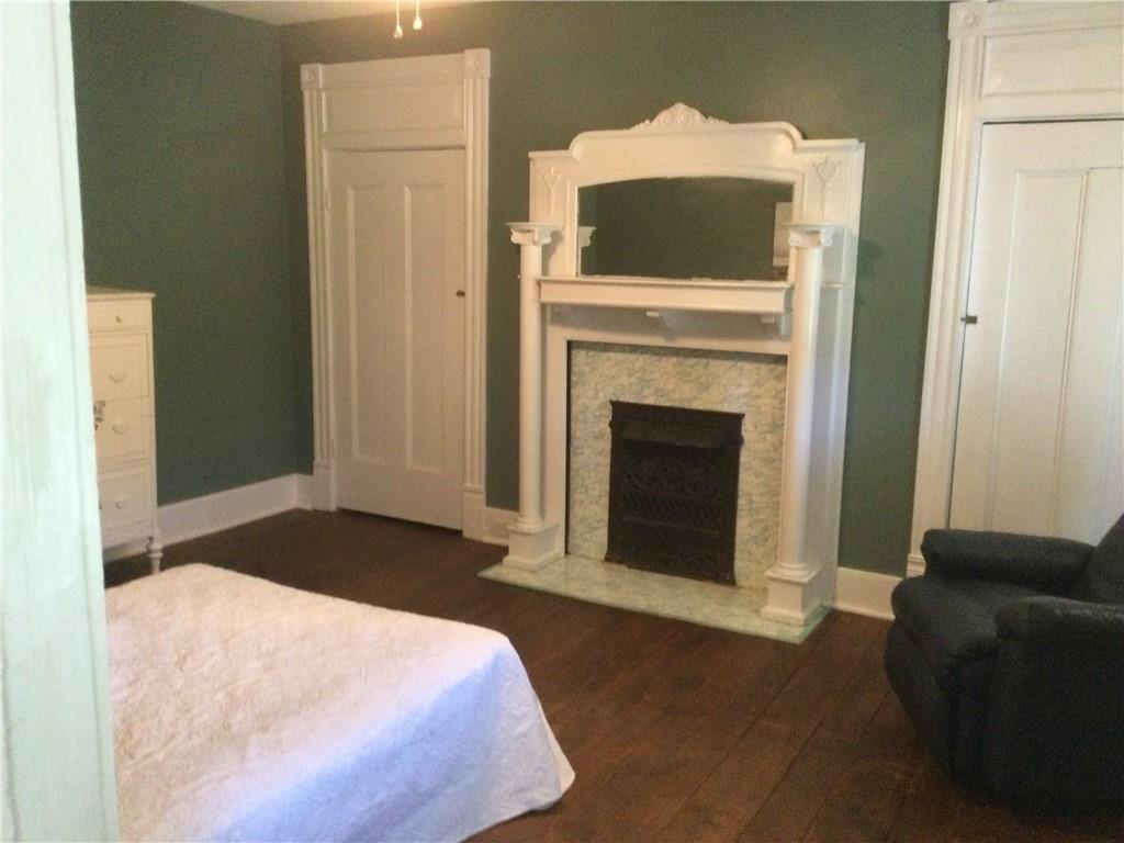109 Woodies Road Waynesburg, PA 15370 - Photo 16 of 33 a bedroom with a bed and a fireplace