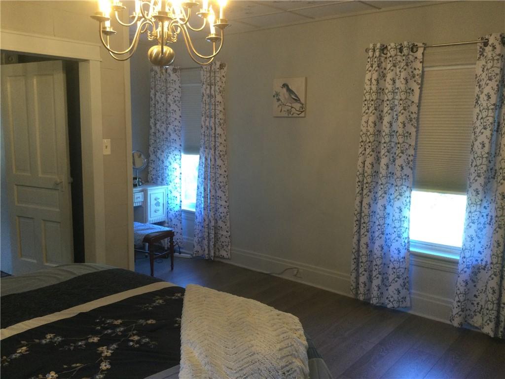 109 Woodies Road Waynesburg, PA 15370 - Photo 20 of 33 a bedroom with a bed and a chandelier