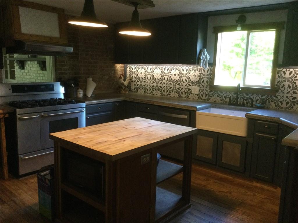 109 Woodies Road Waynesburg, PA 15370 - Photo 8 of 33 a kitchen with stainless steel appliances granite countertop wooden cabinets a stove a sink and a refrigerator