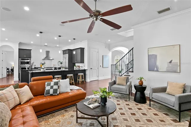 a living room with furniture kitchen view and a table