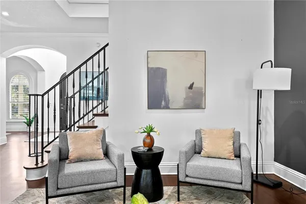 a living room with furniture and wooden floor