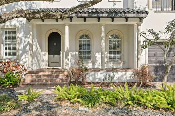 a front view of a house with a garden