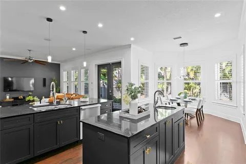 a kitchen with sink a stove and cabinets