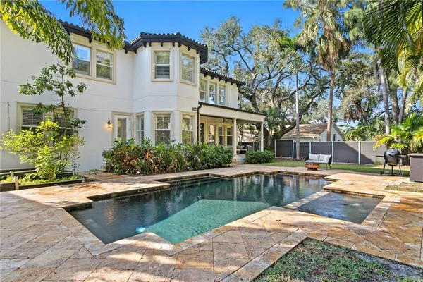 a house with swimming pool in front of it