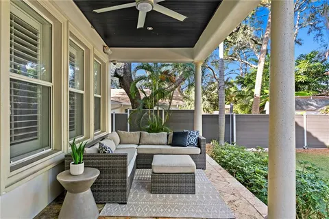 a view of a patio with couches table and chairs and potted plants