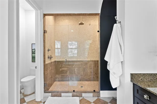 a bathroom with a granite countertop sink tub and a mirror