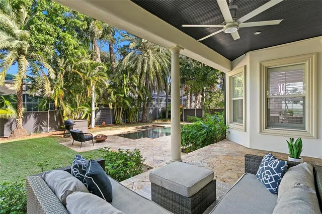 a view of a patio with couches and table and chairs with plants
