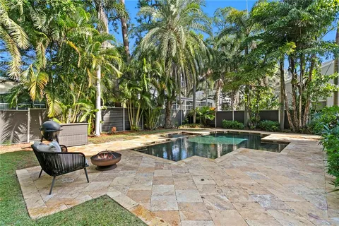 a view of swimming pool with chairs and tables
