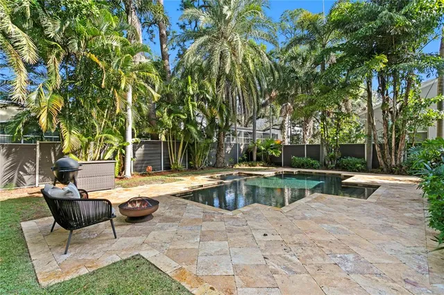 a view of swimming pool with chairs and tables