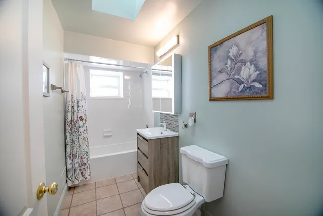 a white toilet sitting next to a bathroom sink