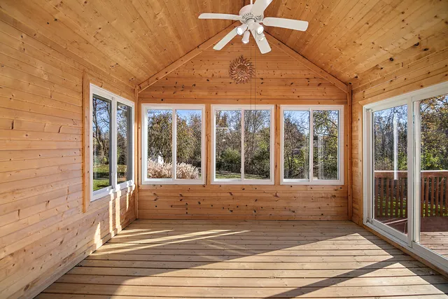 a view of a livingroom with a ceiling fan and window