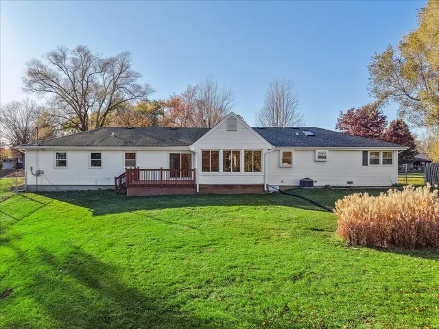 a front view of a house with a garden and yard