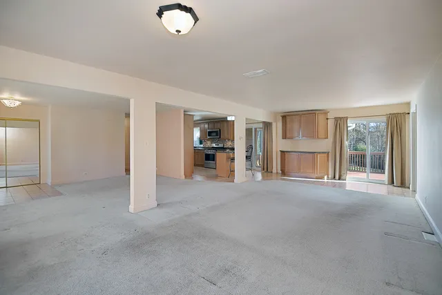 a view of empty room with a fireplace