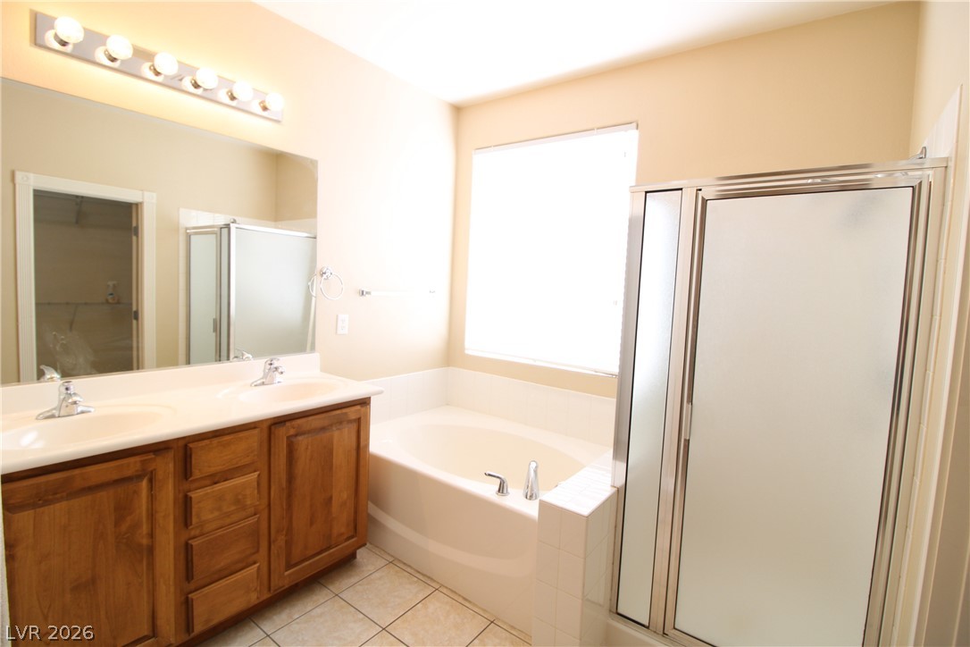 754 Rise Canyon Drive Henderson, NV 89052 - Photo 24 of 34 Double vanity and a soaking tub offer a serene escape in this well-appointed bath.