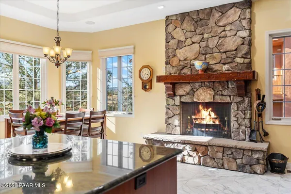 a kitchen with a table a stove and a fireplace