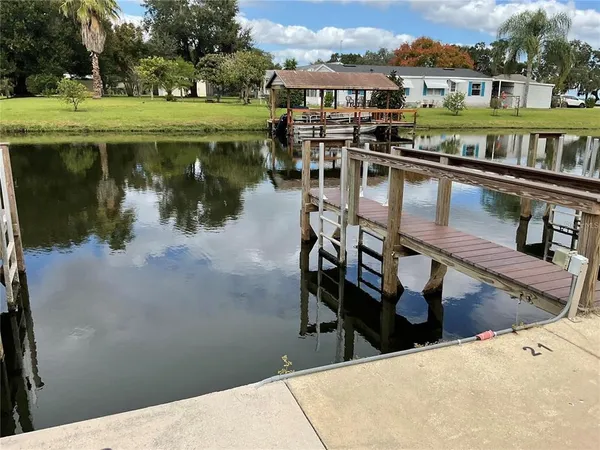 a view of a lake with a table and chairs