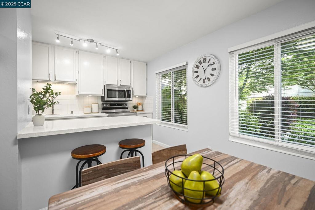 2560 Walnut Boulevard Walnut Creek, CA 94596 - Photo 6 of 29 a kitchen with stainless steel appliances a dining table chairs and window