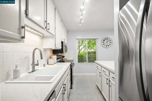 a view of a bedroom with a window and a chandelier