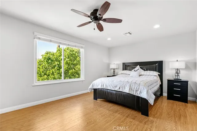 a bedroom with a bed and a ceiling fan