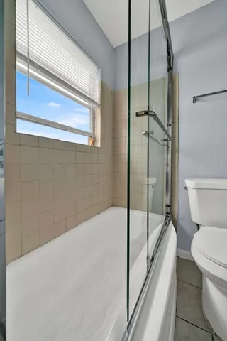a bathroom with a toilet and a shower