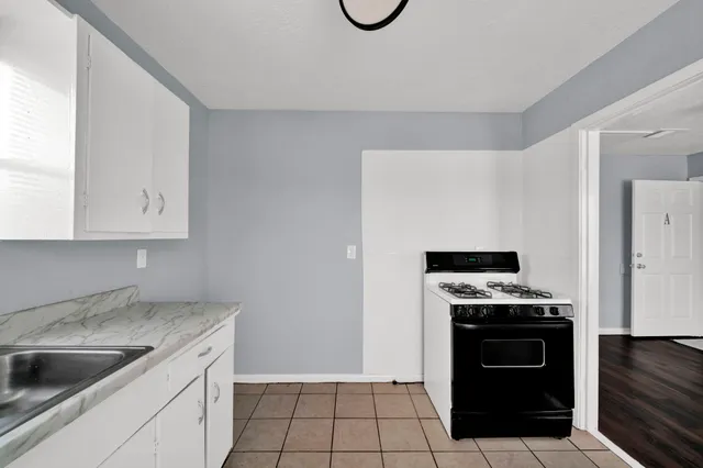 a kitchen with granite countertop a stove and a sink