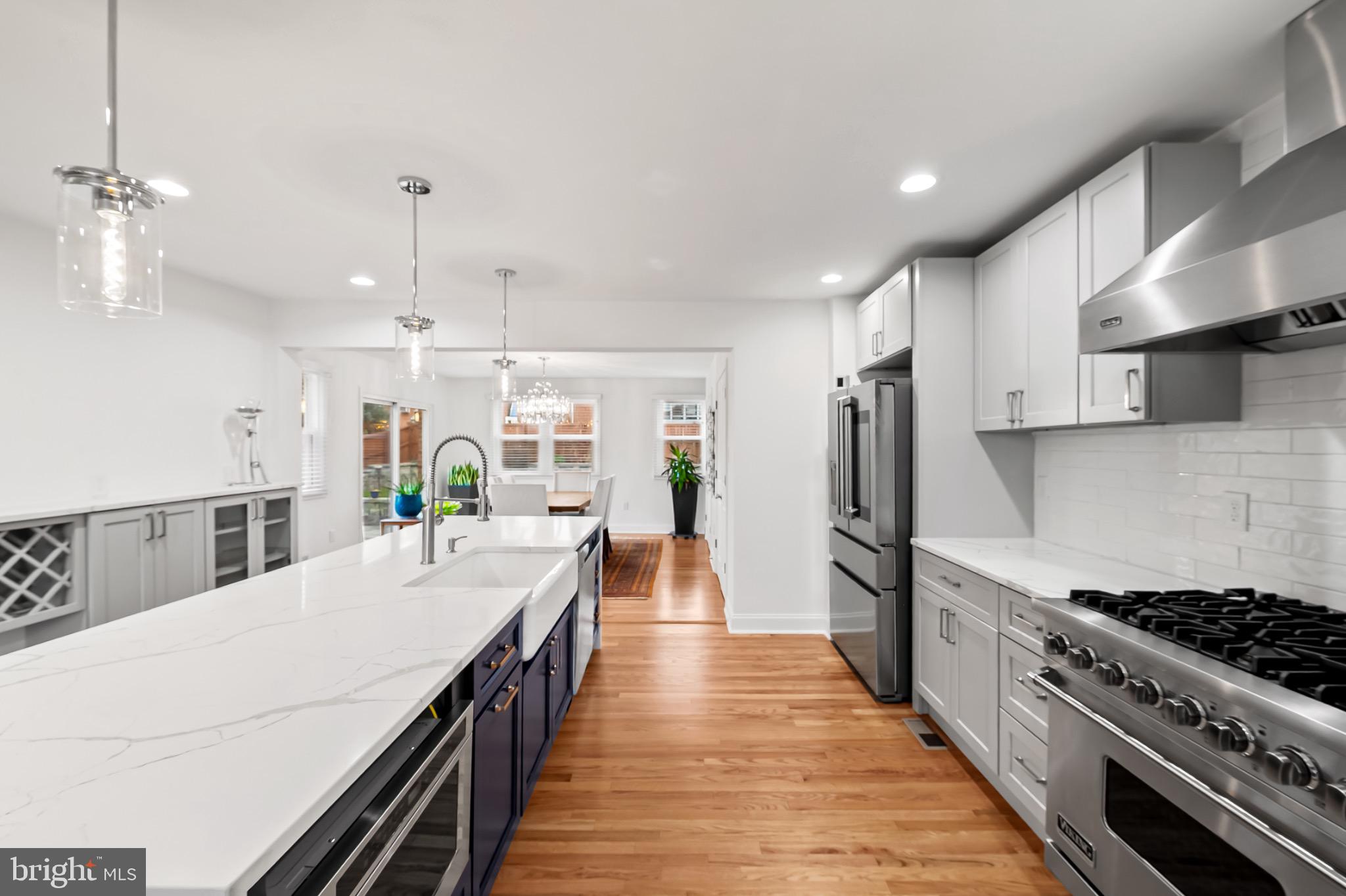 312 Waveland Road Catonsville, MD 21228 - Photo 12 of 40 a kitchen with stainless steel appliances a stove a sink a refrigerator and chairs